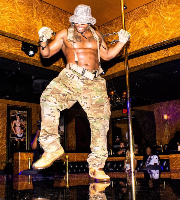 Male stripper in army-inspired costume performing at Men of Vega Club