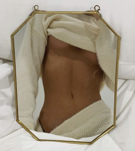 Using a mirror to pose for nude photography